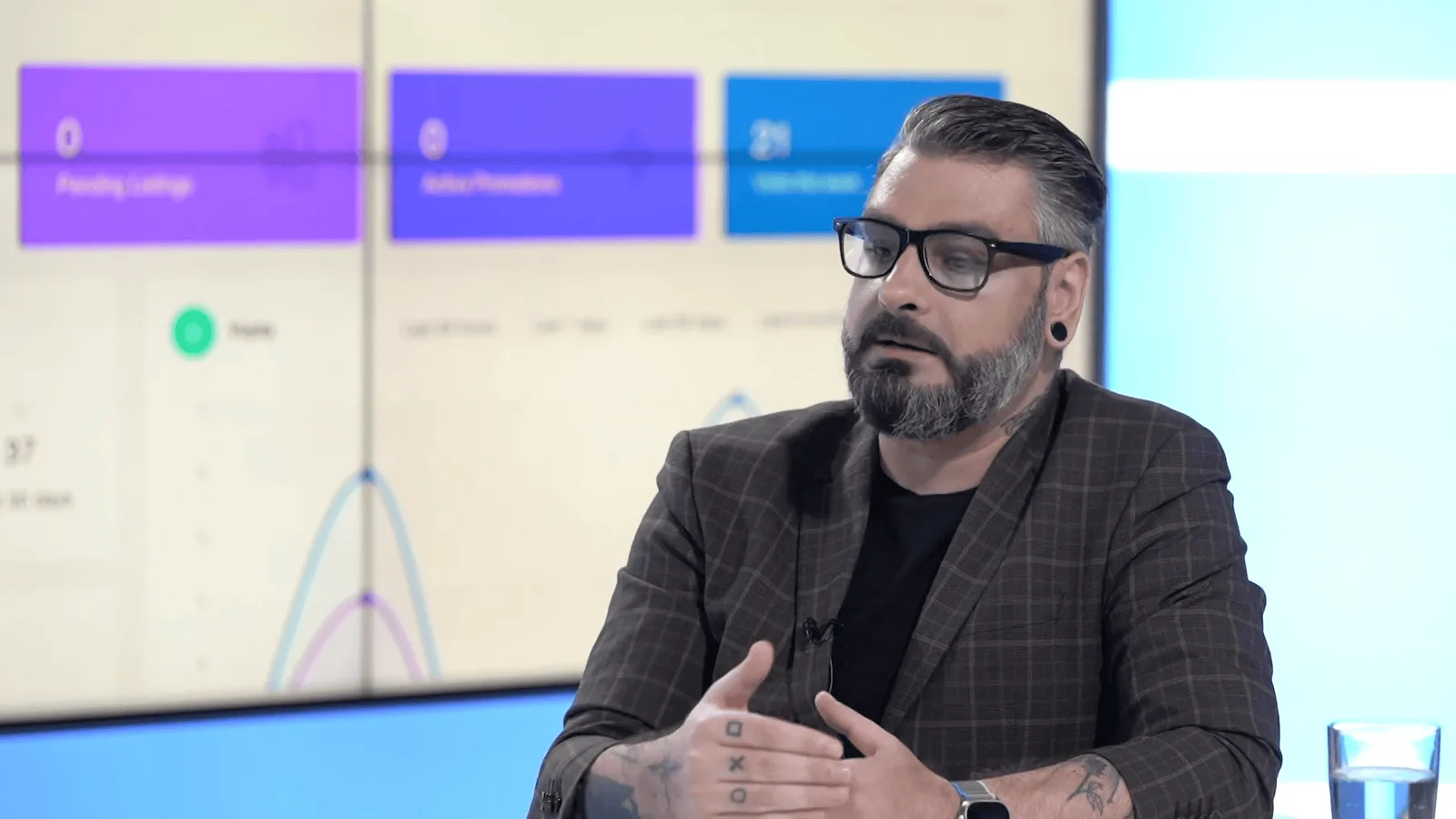 Being interviewed in a studio with the MyRoomie dashboard displayed on the wall behind