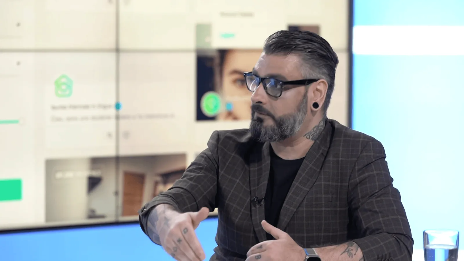 Gesturing towards a studio screen showing MyRoomie listings during an interview